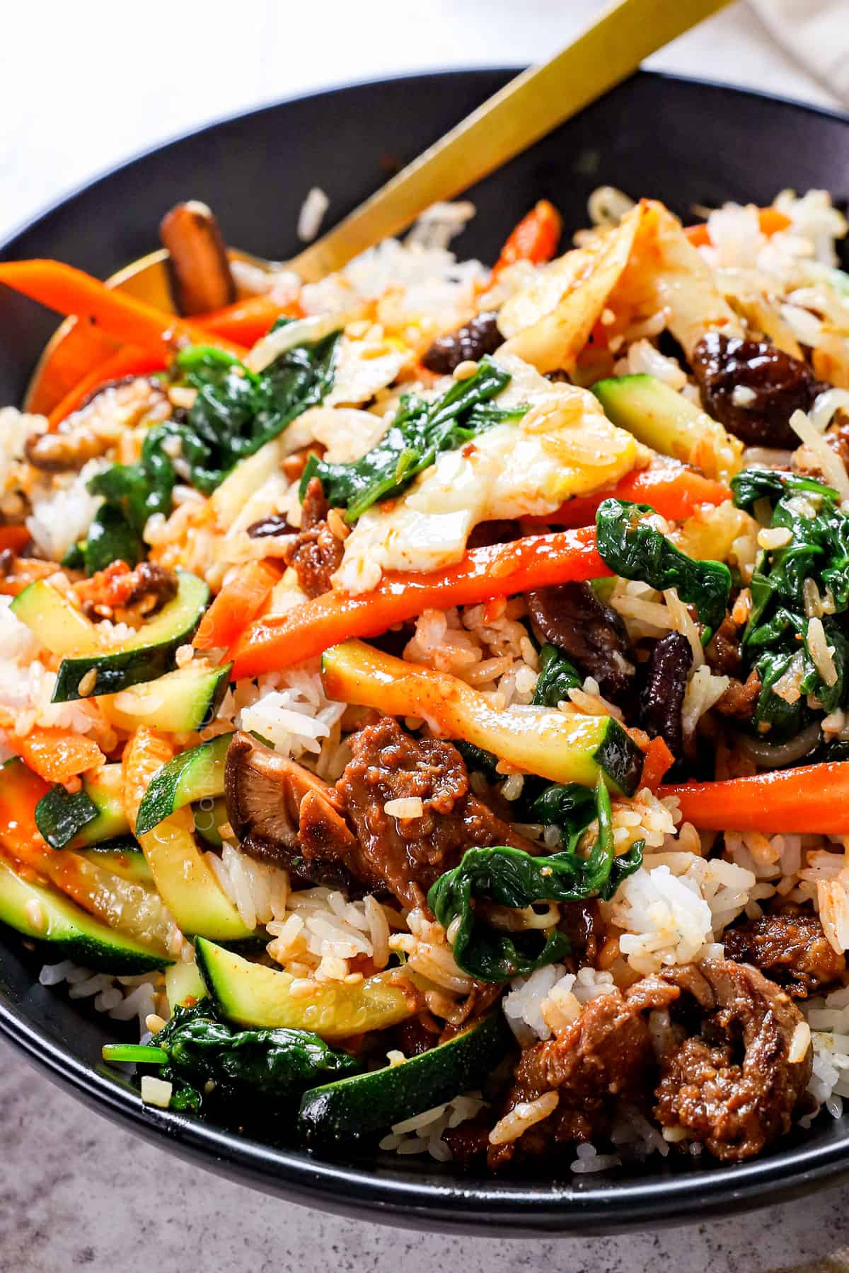 up close of bibimbap recipe after mixing all of the ingredients together in a bowl