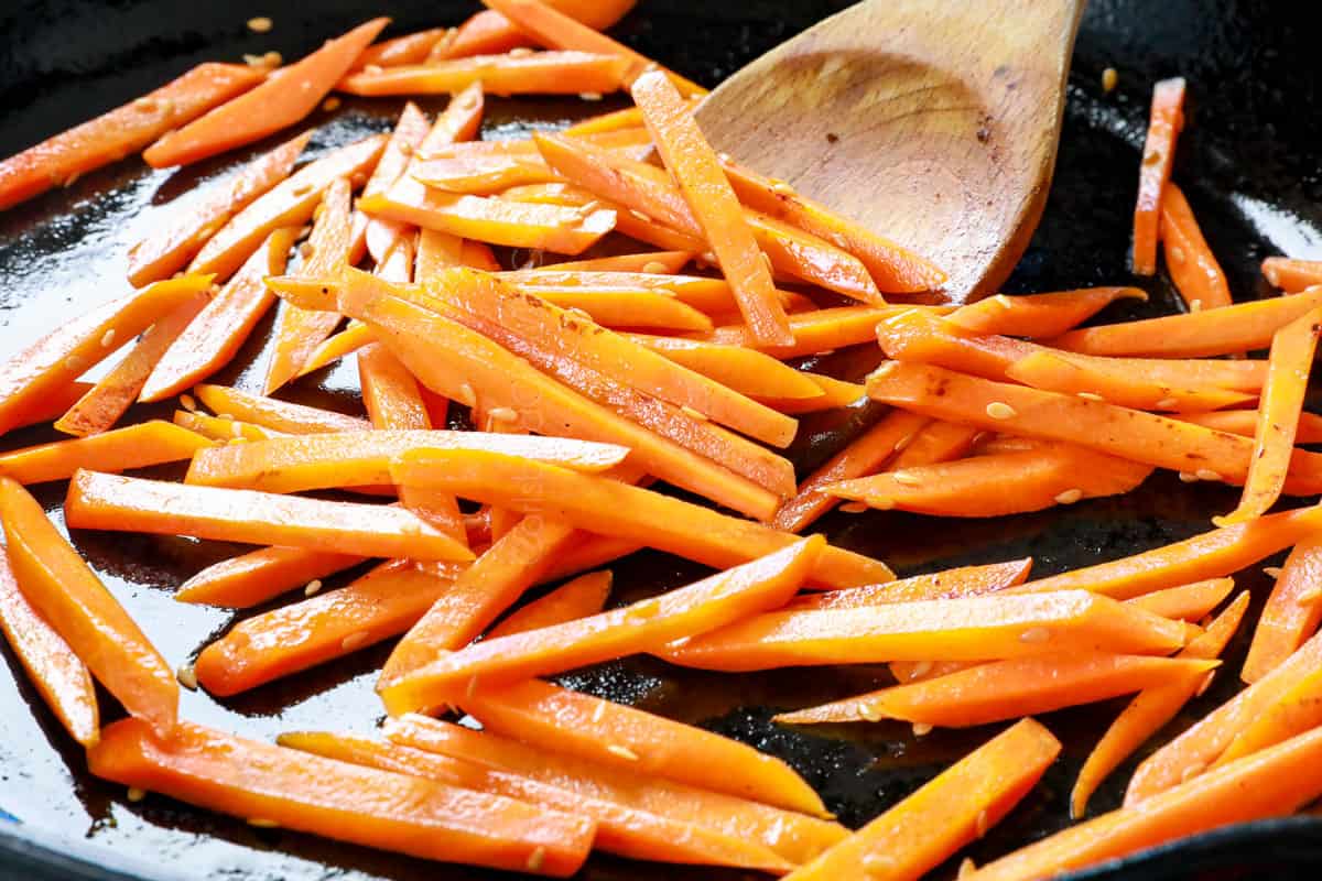 showing how to make bibimbap recipe by stir frying sliced carrots