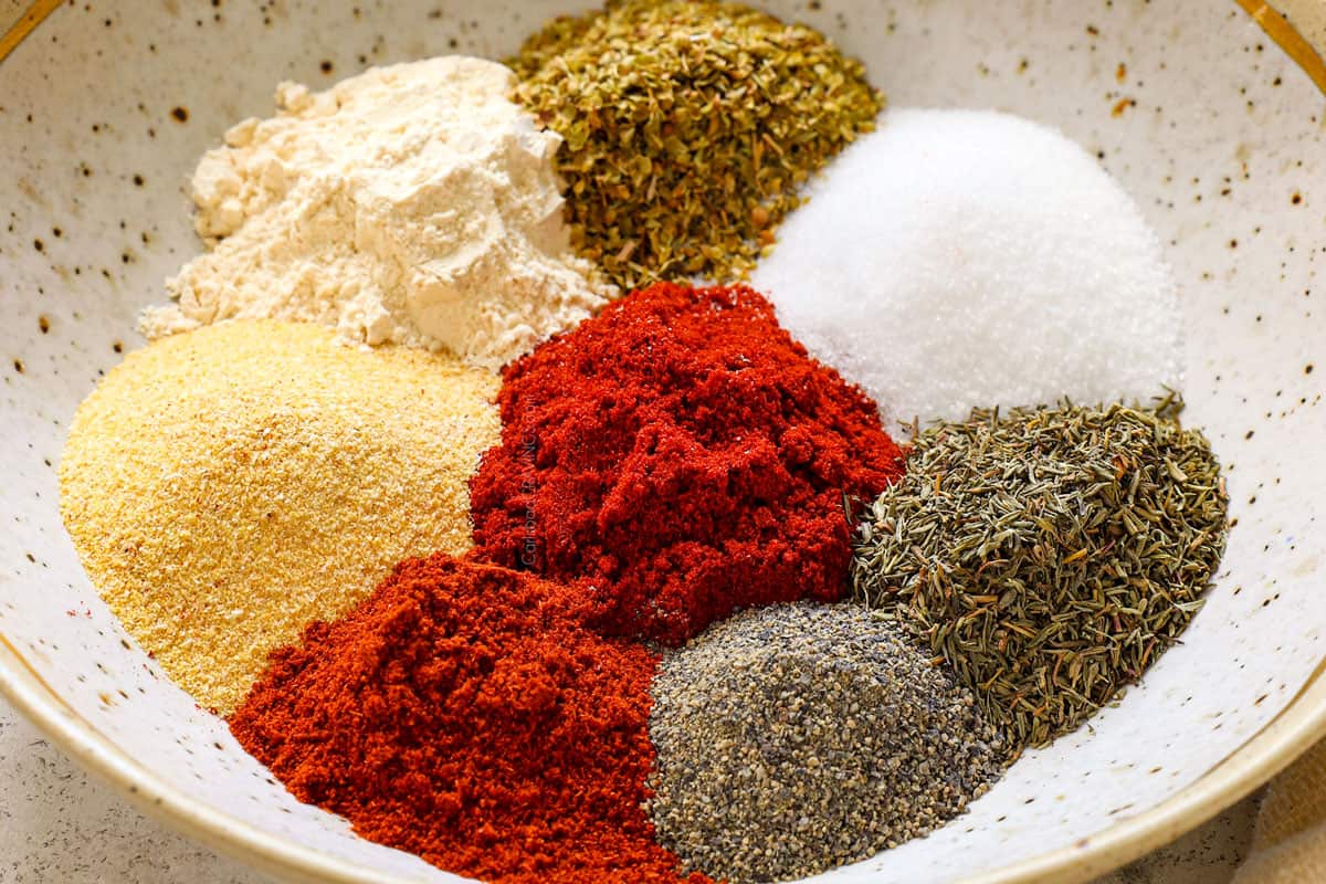 showing how to make Cajun seasoning by add all of the spices to a bowl