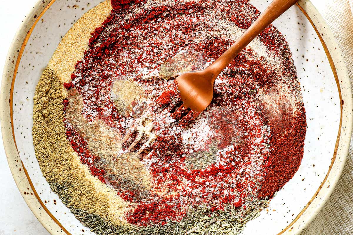 showing how to make Cajun seasoning recipe by whisking the spices together until evenly combined