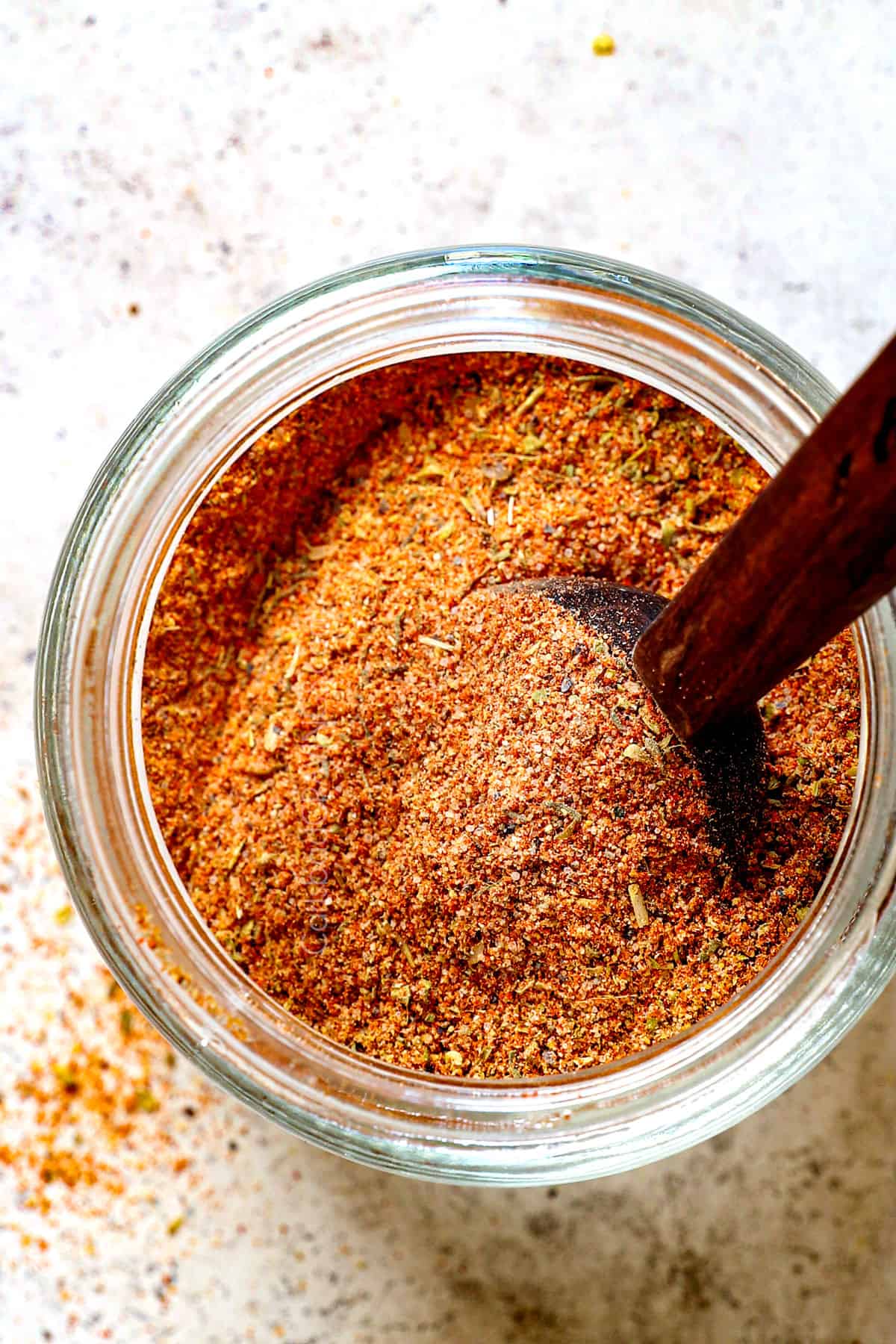 showing how to store homemade Cajun seasoning in a jar