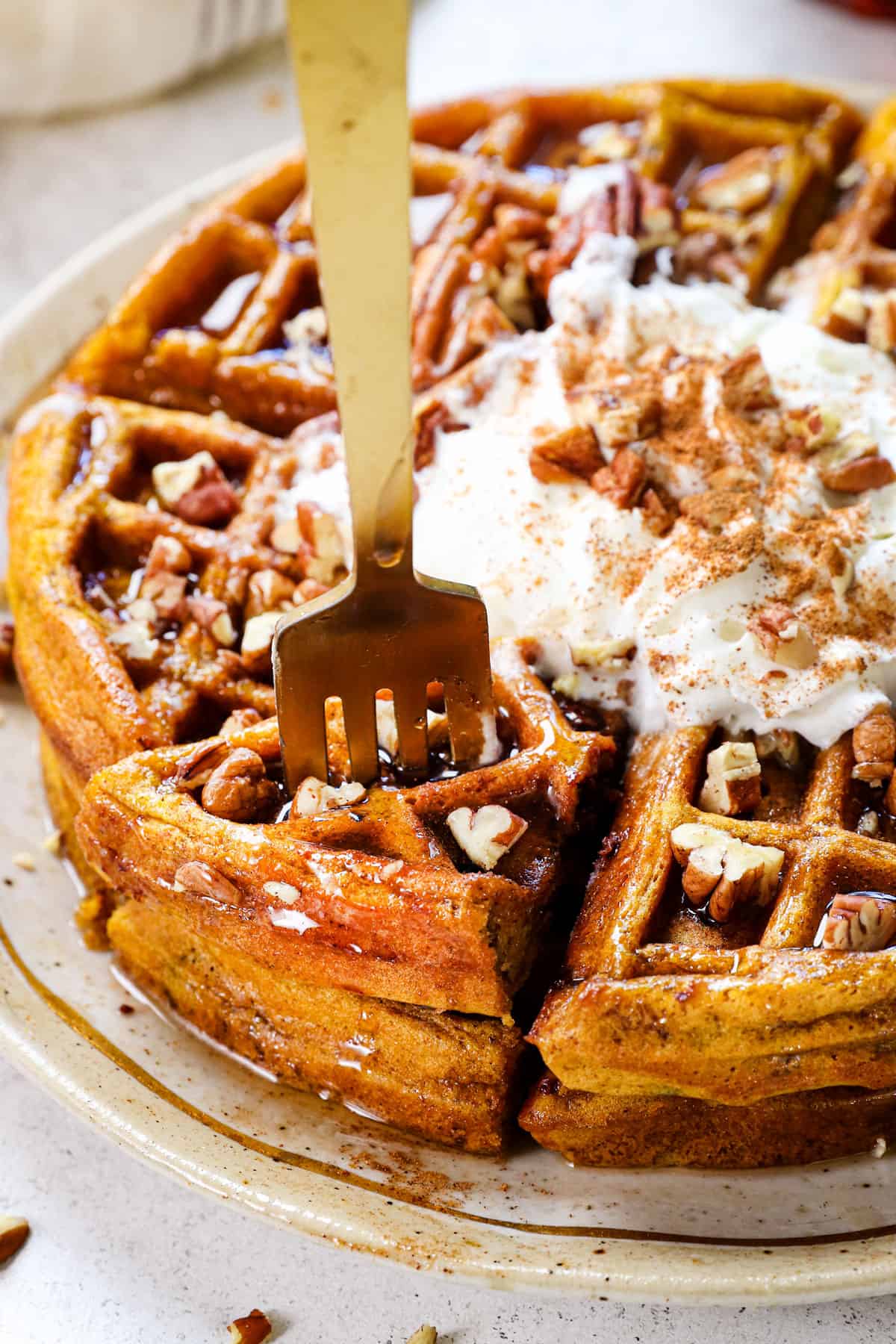 pumpkin waffles being served on a plate with syrup