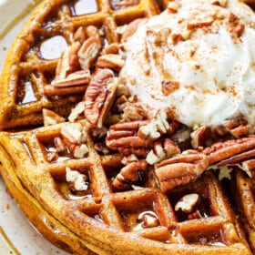 pumpkin waffles recipe topped with whipped cream