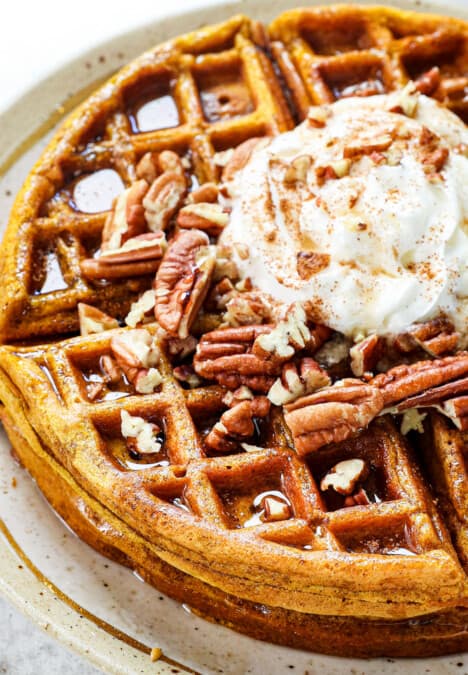 pumpkin waffles recipe topped with whipped cream