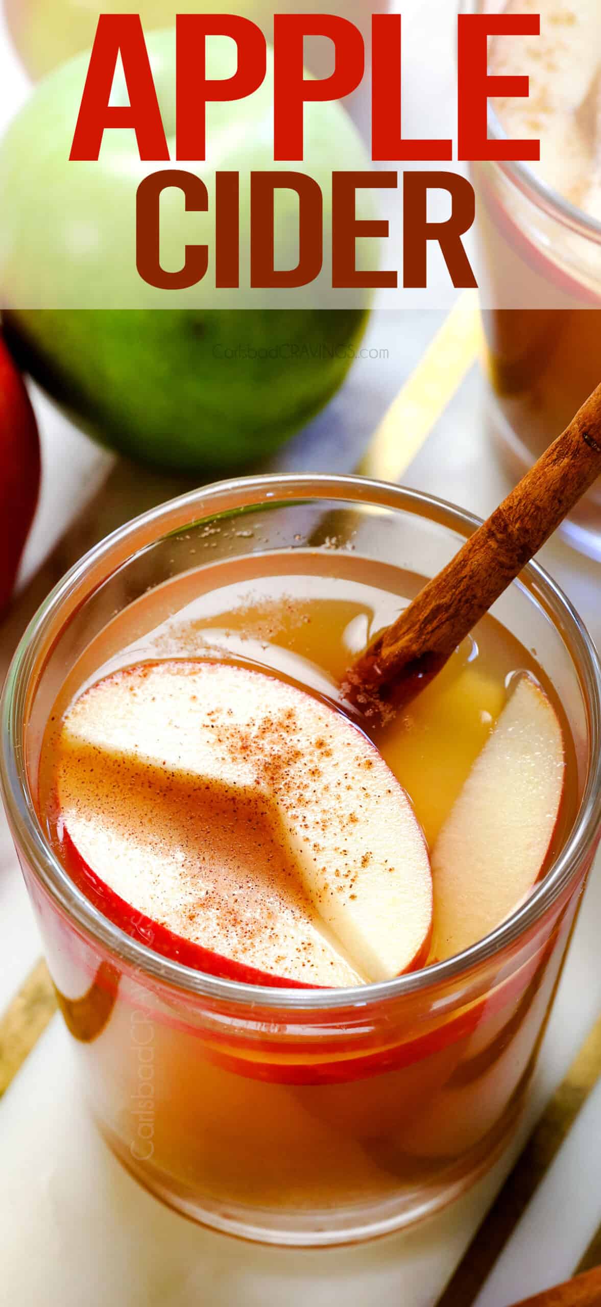 apple cider in a glass garnished with apple cider and cinnamon