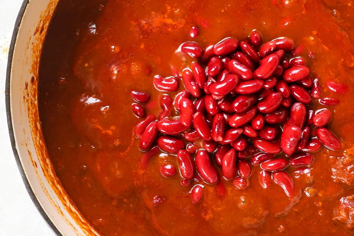 showing how to make chili con carne (beef chili recipe) by adding beans