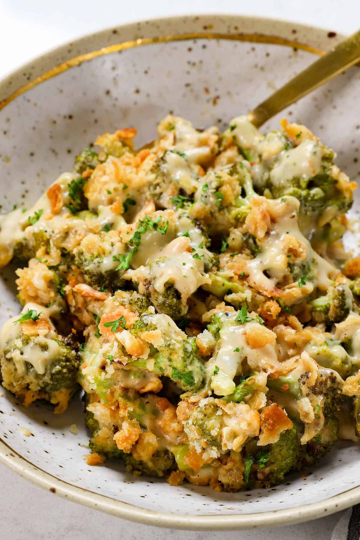serving cheesy broccoli casserole in a plate
