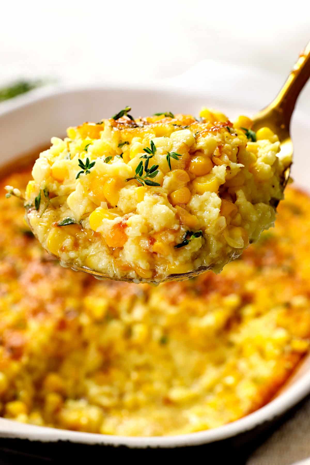 up close of a serving scoop of corn pudding showing how creamy it is