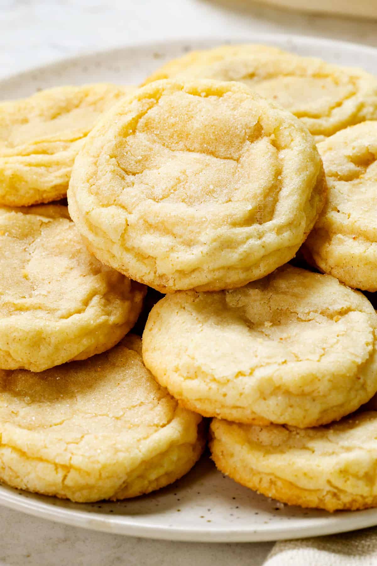 a plate of best sugar cookie recipe showing how thick, soft and chewy they are