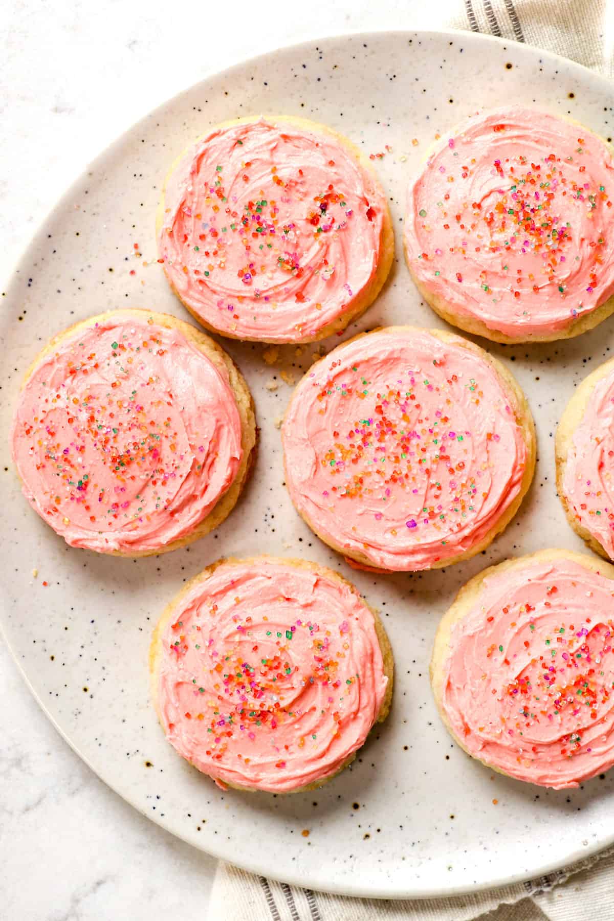 top view of simple sugar cookie recipe with frosting decorated with sprinkles
