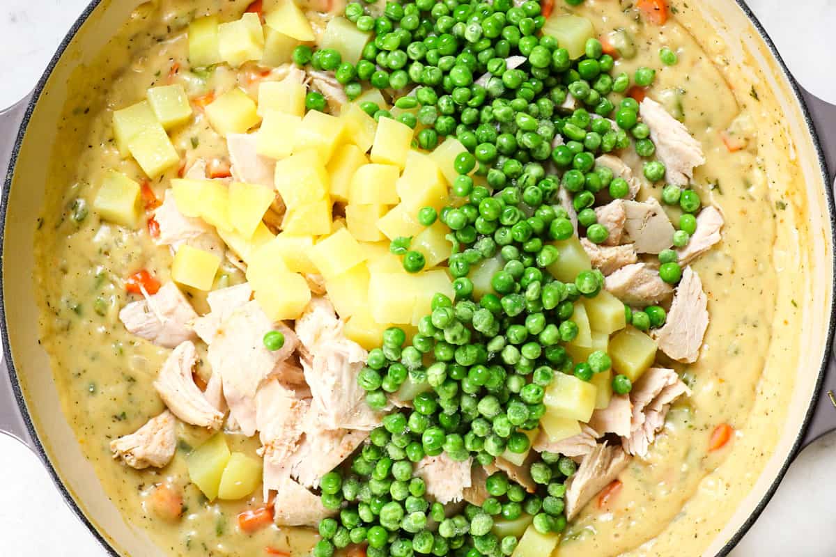 showing how to make turkey pot pie by adding potatoes, turkey and peas to the sauce