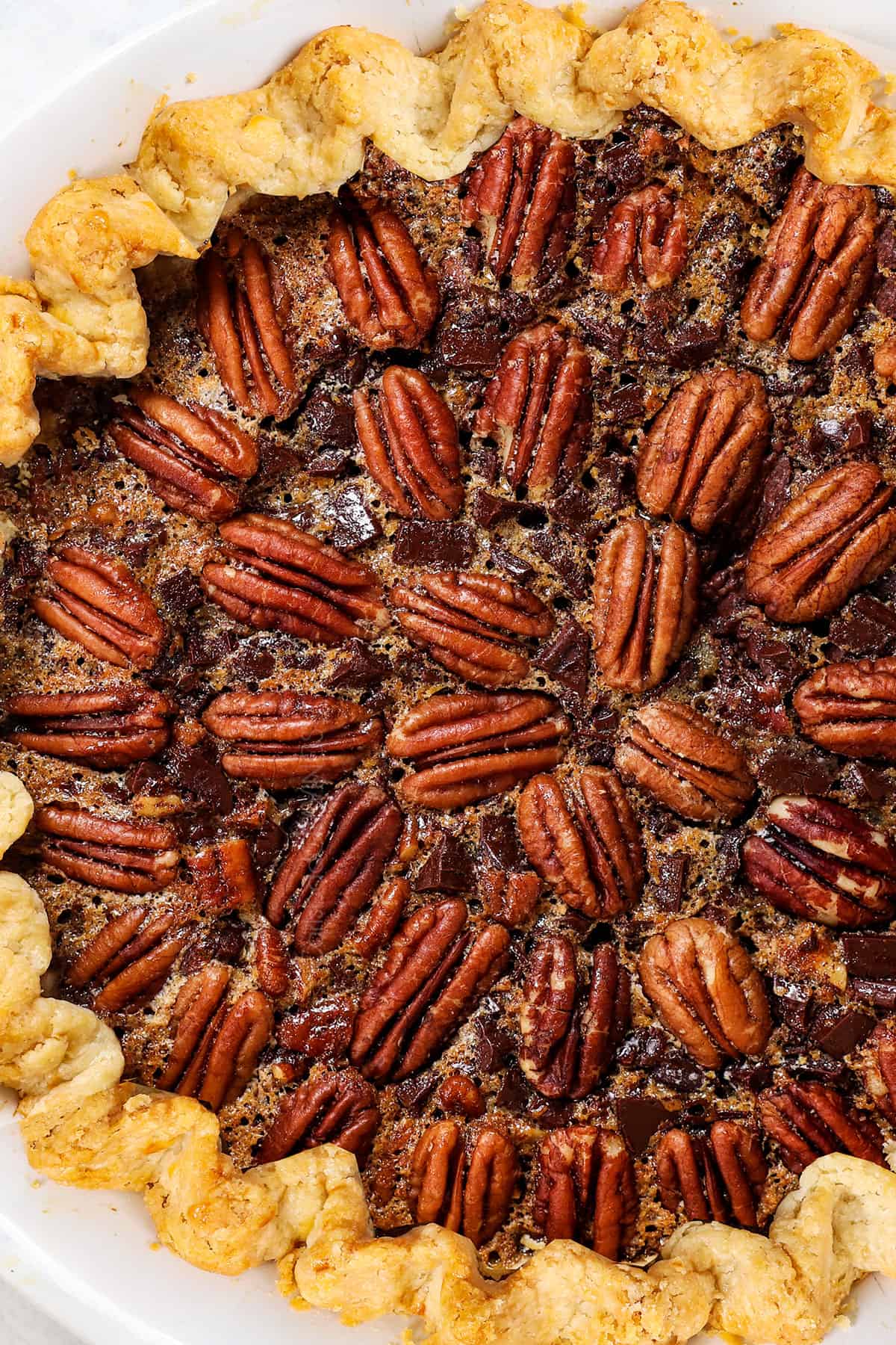 top view of chocolate pecan pie showing the decorative pattern of pecans on top