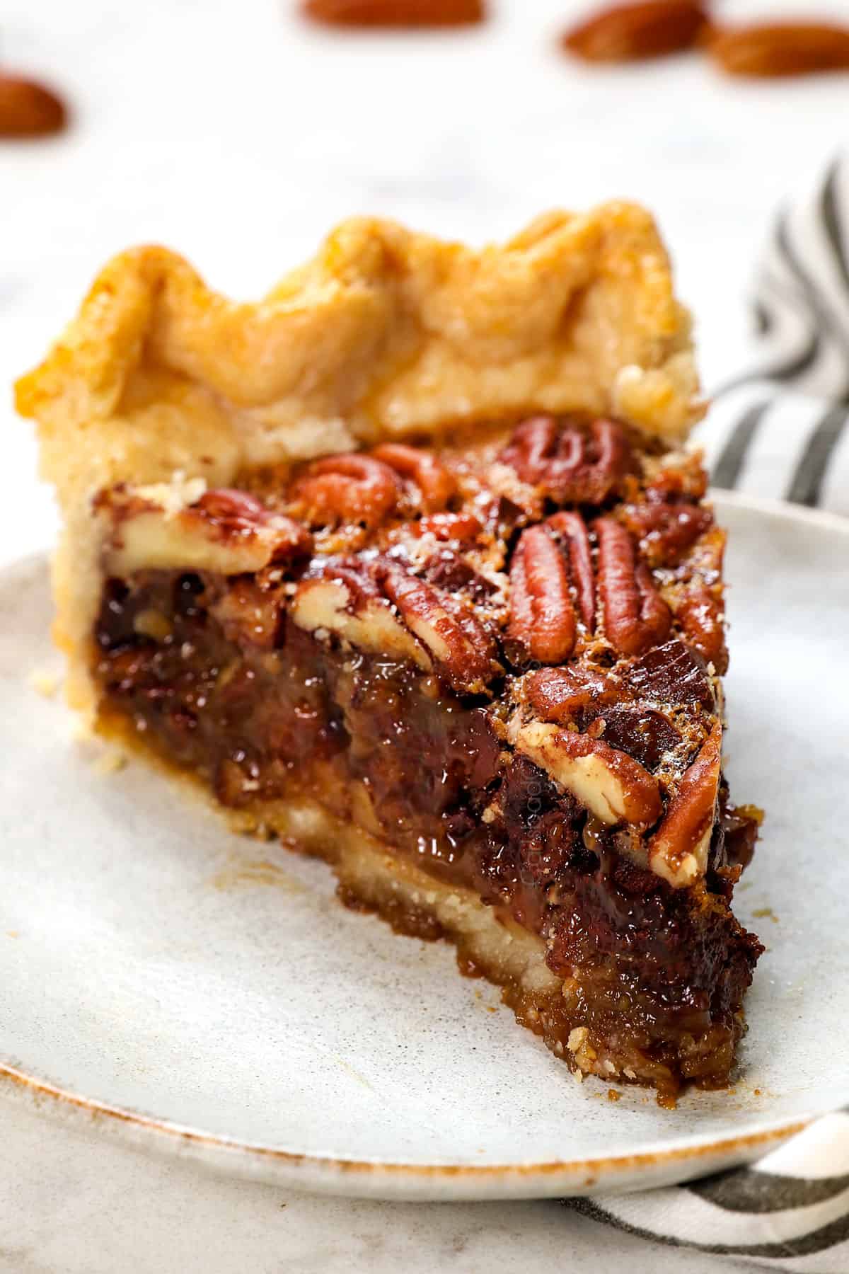 showing how to serve chocolate pecan pie recipe with a slice on a plate