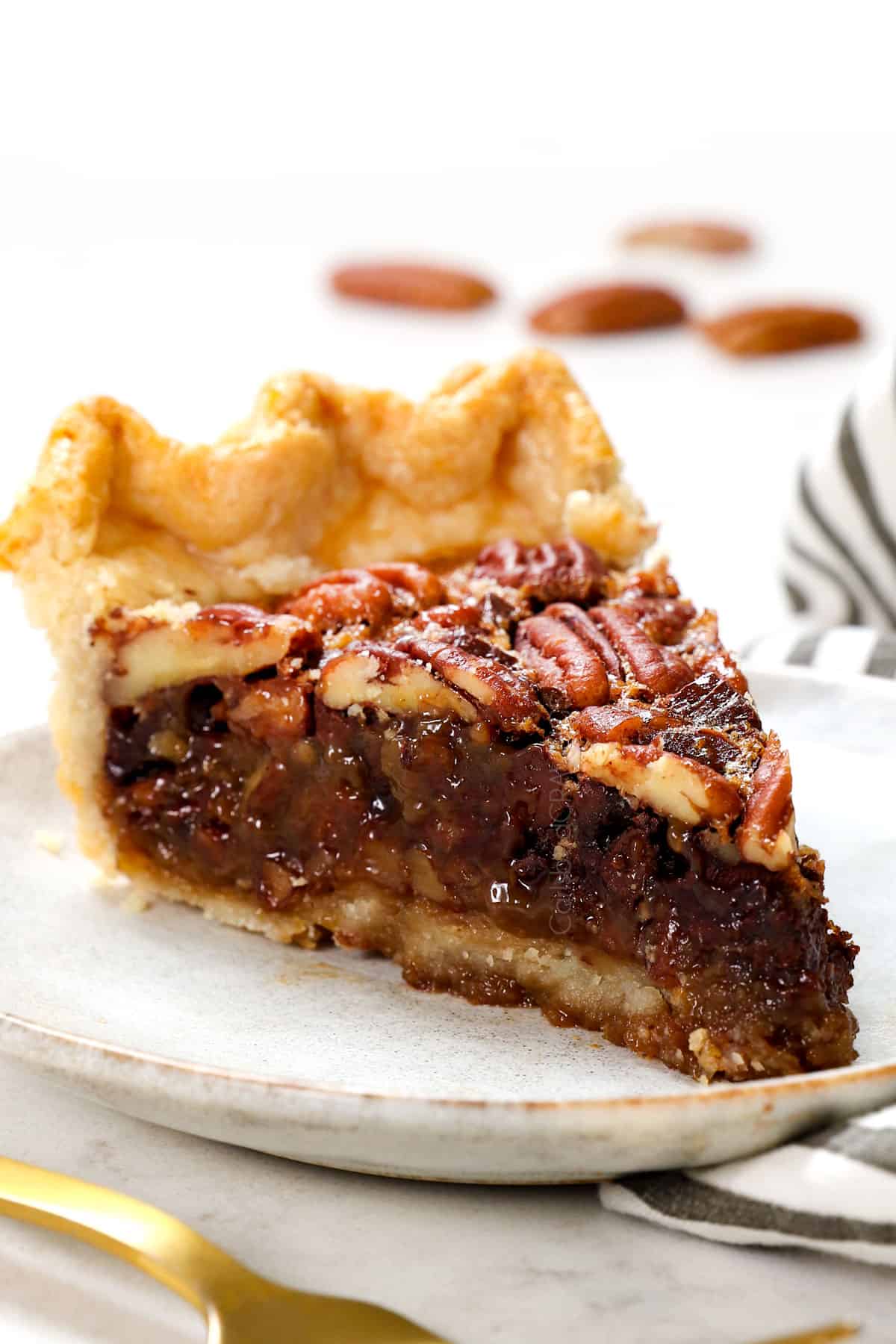 a slice of chocolate pecan pie recipe showing the gooey filling