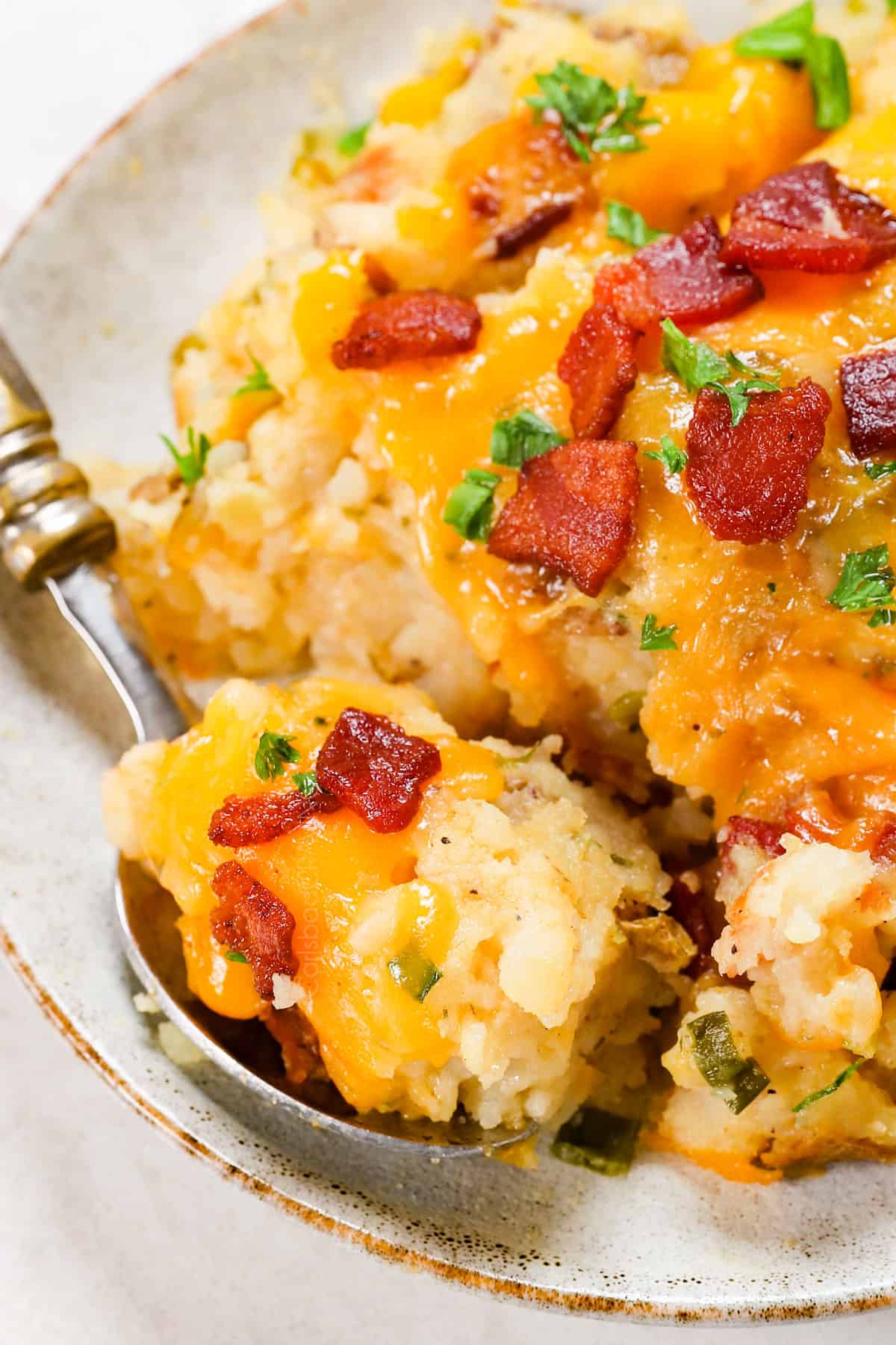 showing how to serve twice baked potato casserole on a plate