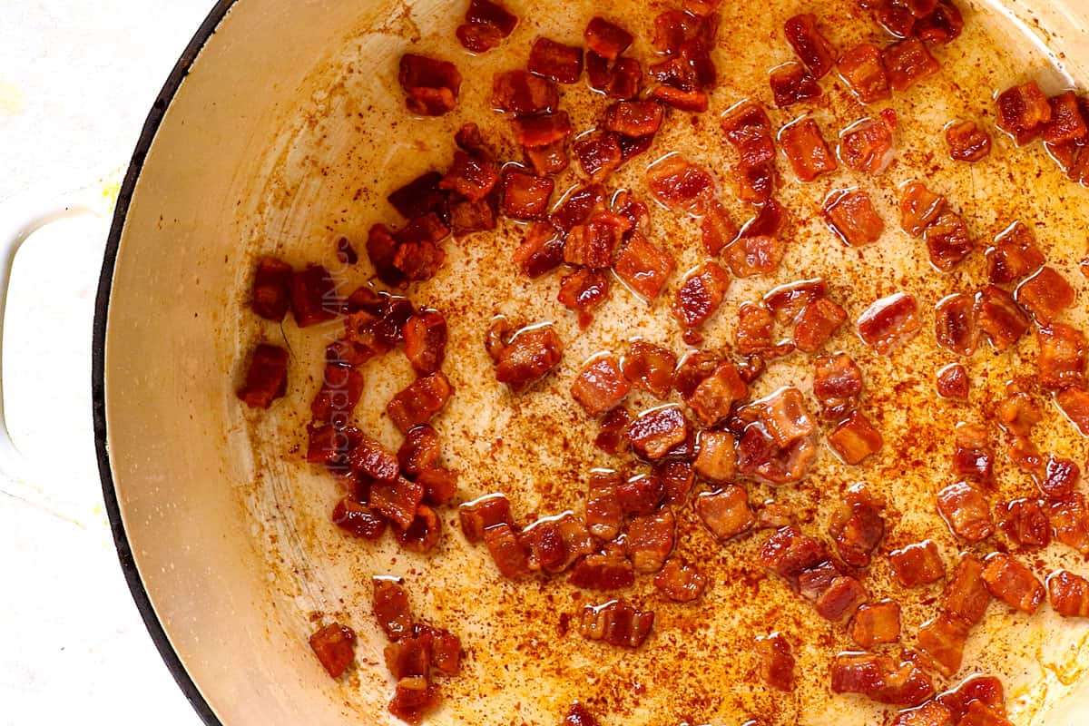 showing how to make twice baked potato casserole by cooking bacon pieces until crispy in a Dutch oven
