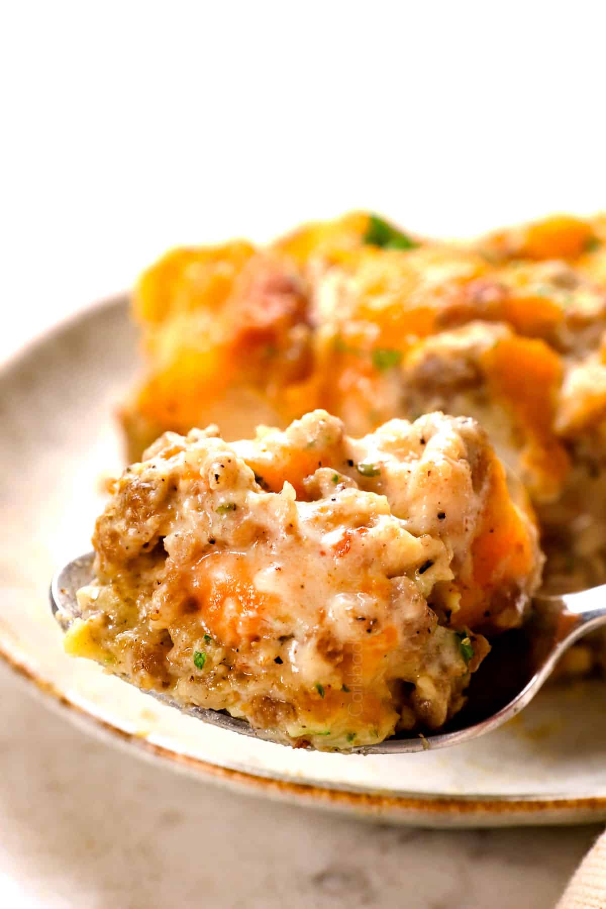 up close of a bite of biscuits and gravy casserole showing how creamy it is