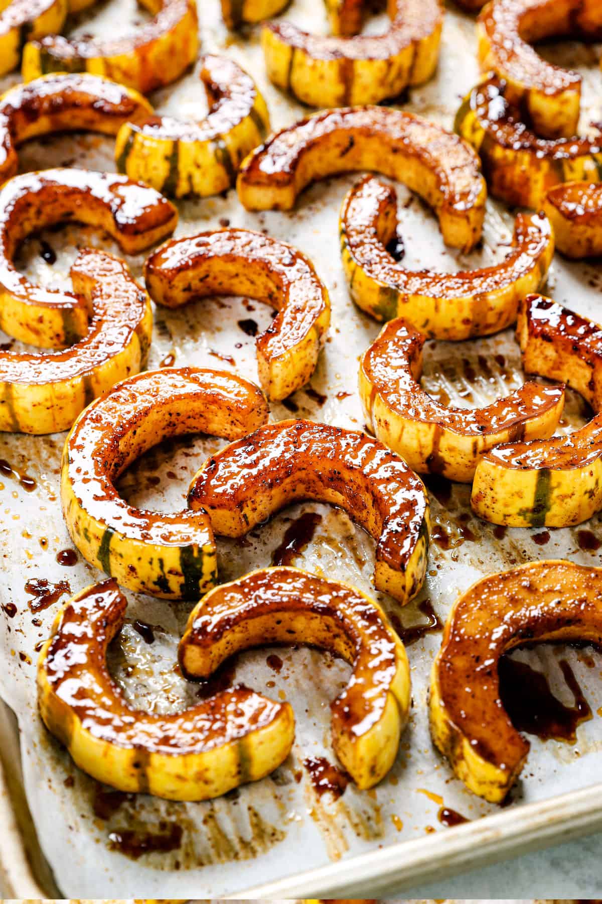 showing how to roast delicata squash on a pan until golden, tender and caramelized