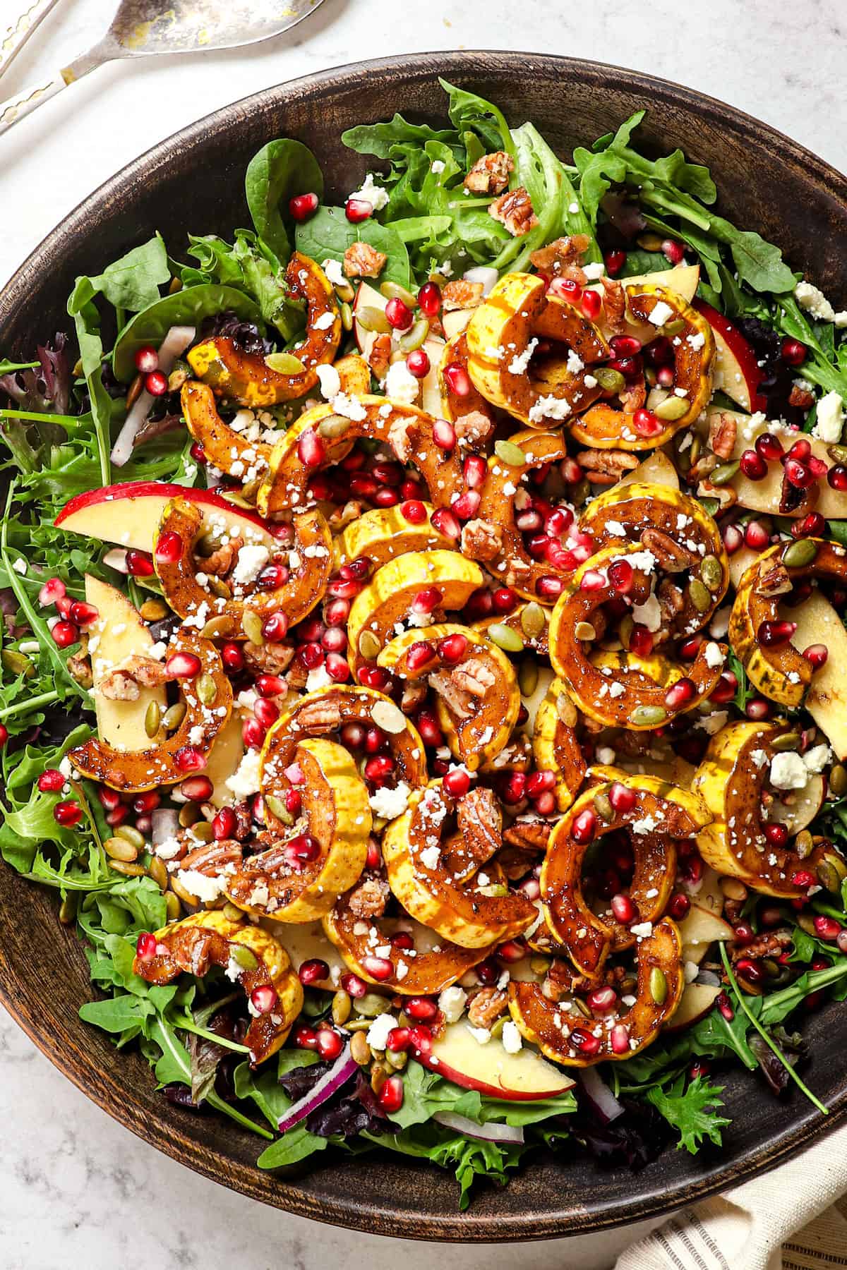 showing how to serve delicata squash by adding to a salad
