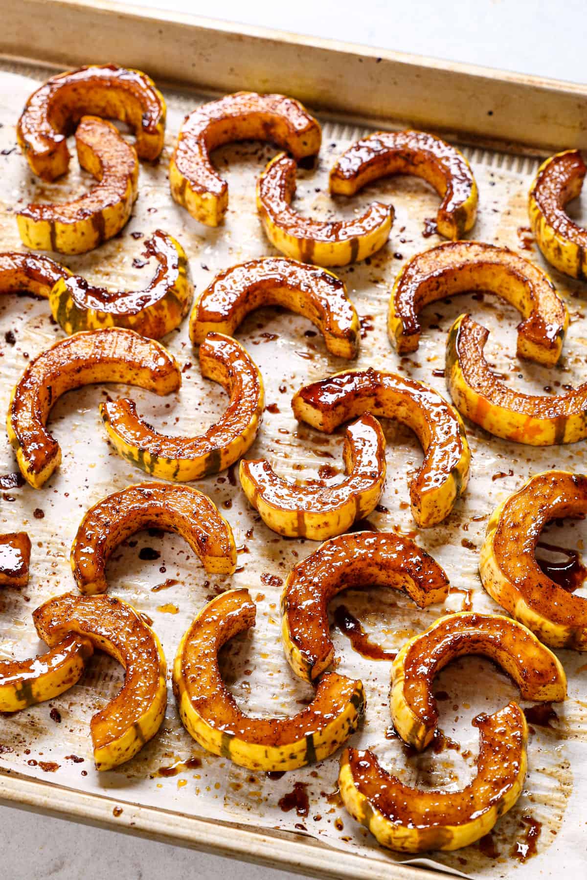 showing how to cook delicata squash by roasting on a pan