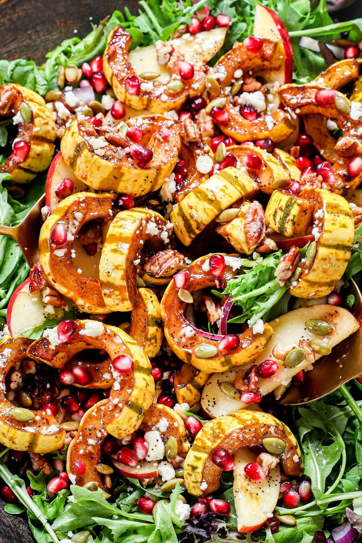 squash salad with pomegranates, apples, feta and seeds