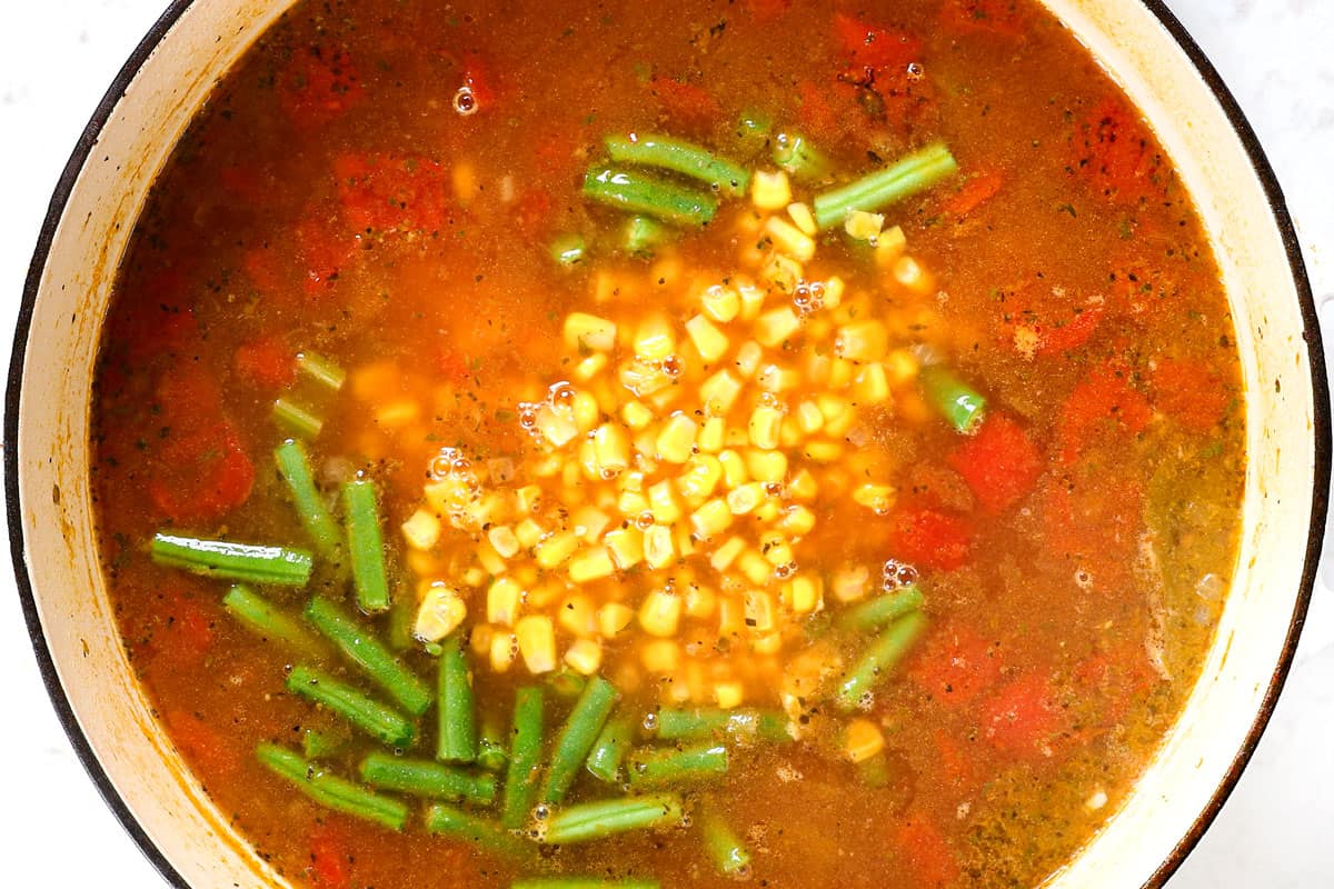 showing how to make chicken vegetable soup by adding green beans and corn