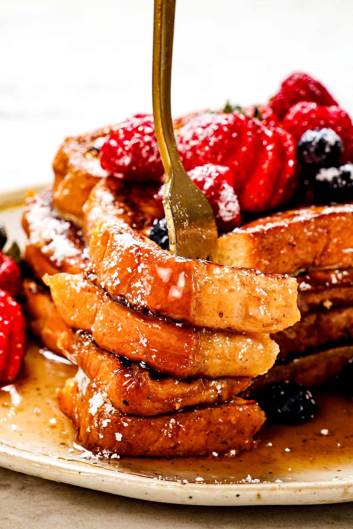 up close of a bite of classic French toast recipe showing how thick and fluffy the French toast is