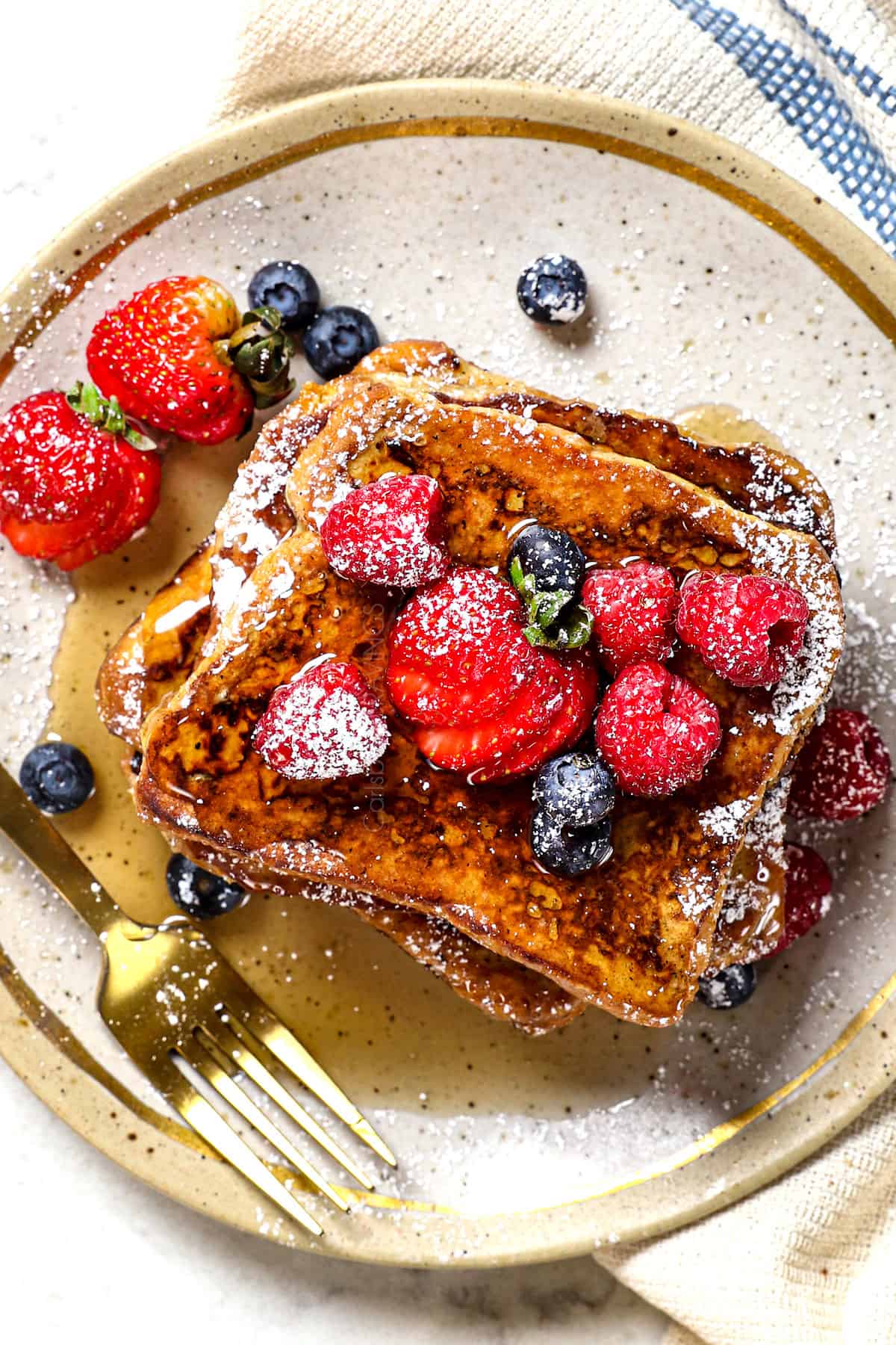 top view of serving simple French toast recipe with berries and powdered sugar