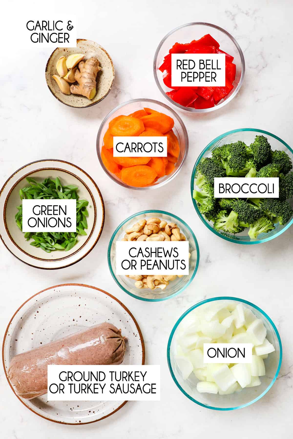 showing ingredients for ground turkey stir fry: ground turkey, broccoli, bell pepper, carrots, onion, ginger, garlic and cashews