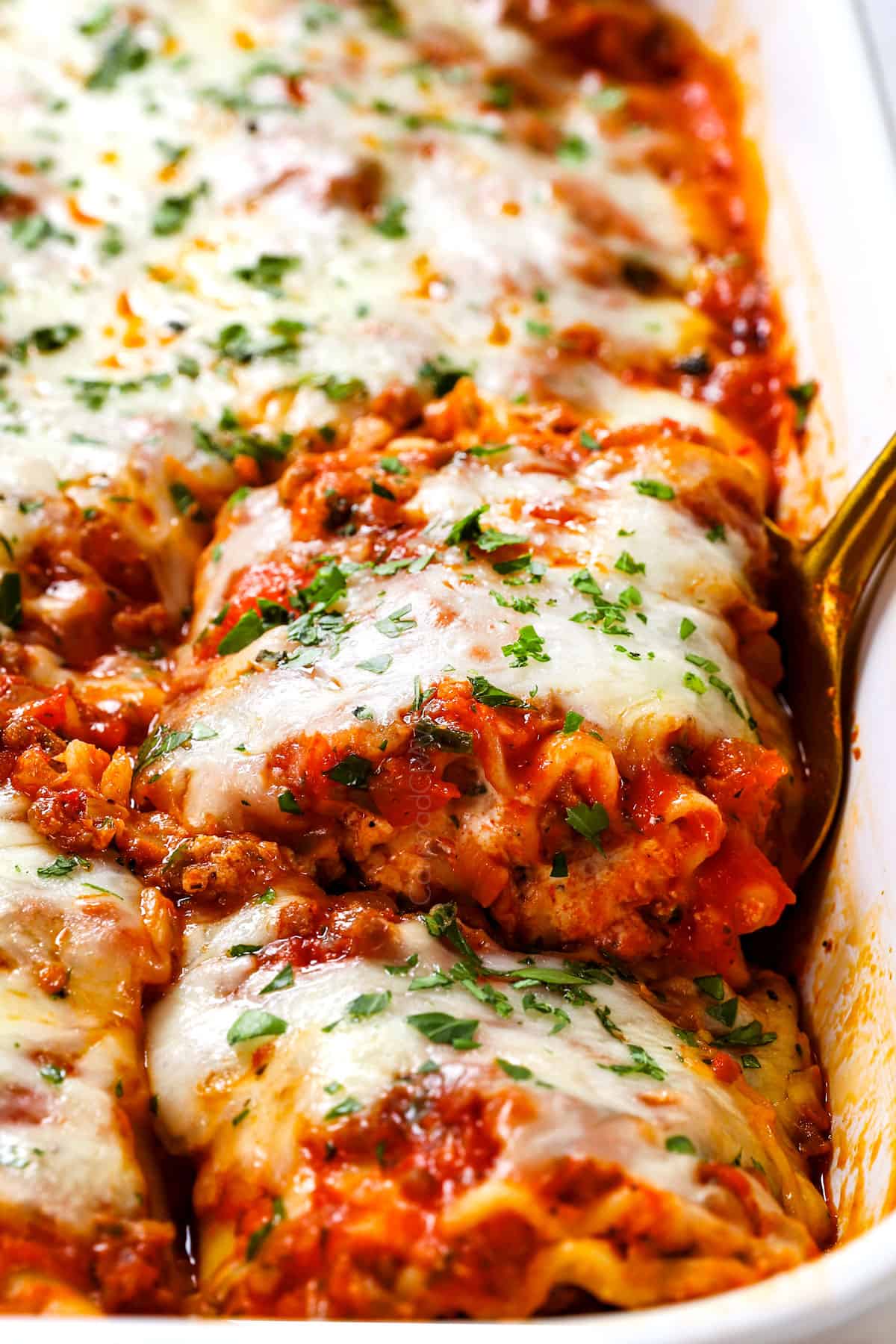 lasagna roll ups served garnished with parsley