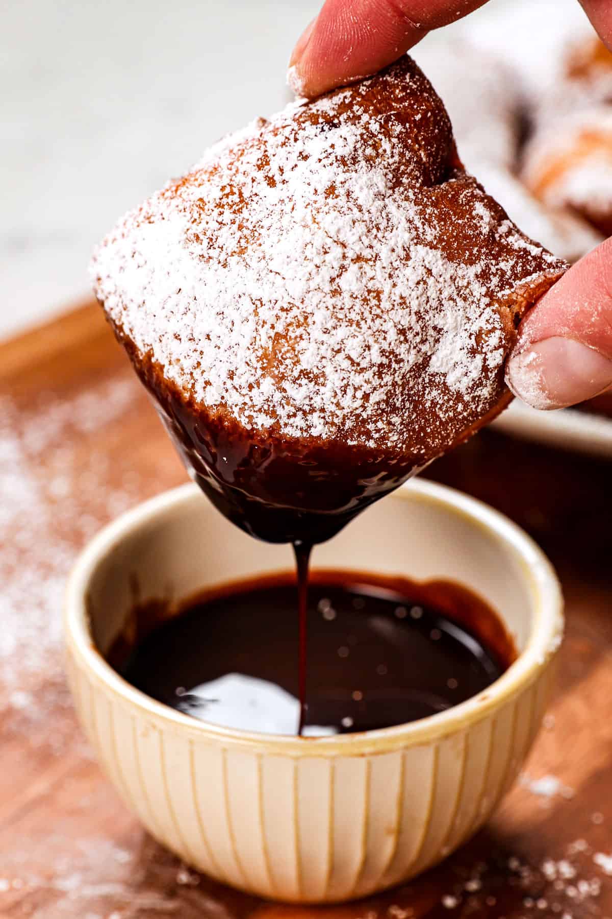 showing how to serve beignets by dipping in chocolate sauce