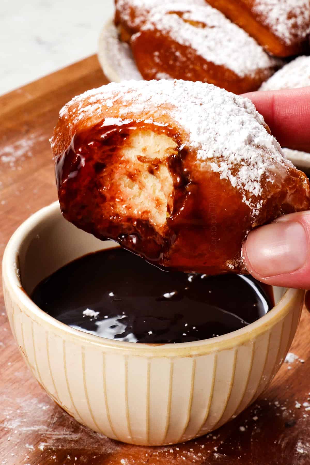 showing what to pair with beignets recipe by serving with chocolate sauce and strawberry compote 