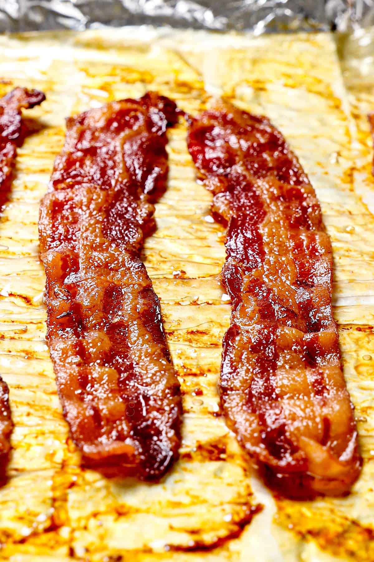 up close of cooking bacon in the oven showing how crispy the slices get