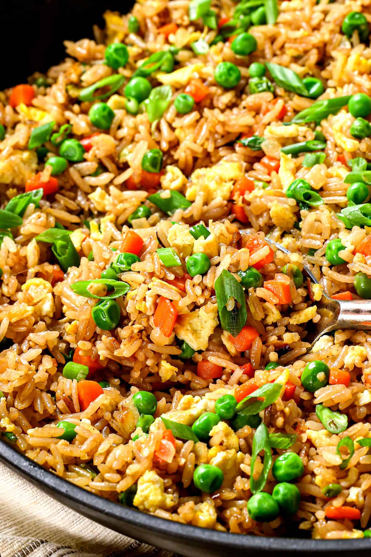 stirring simple fried rice recipe showing all the vegetables