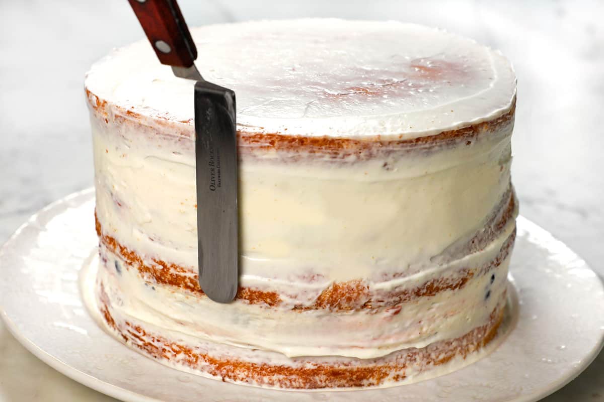 showing how to make Chantilly Cake recipe by frosting with a crumb coat