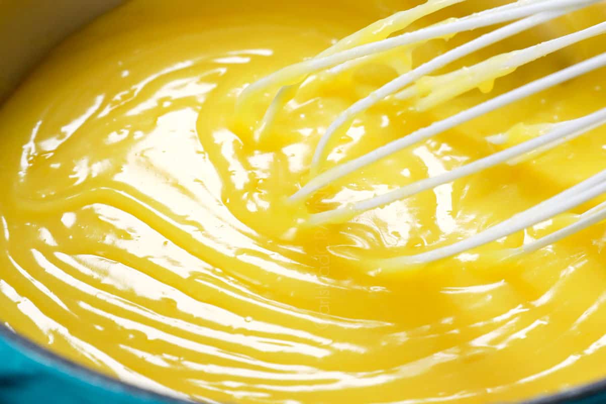 showing how to make lemon pie by cooking lemon filling until thickened