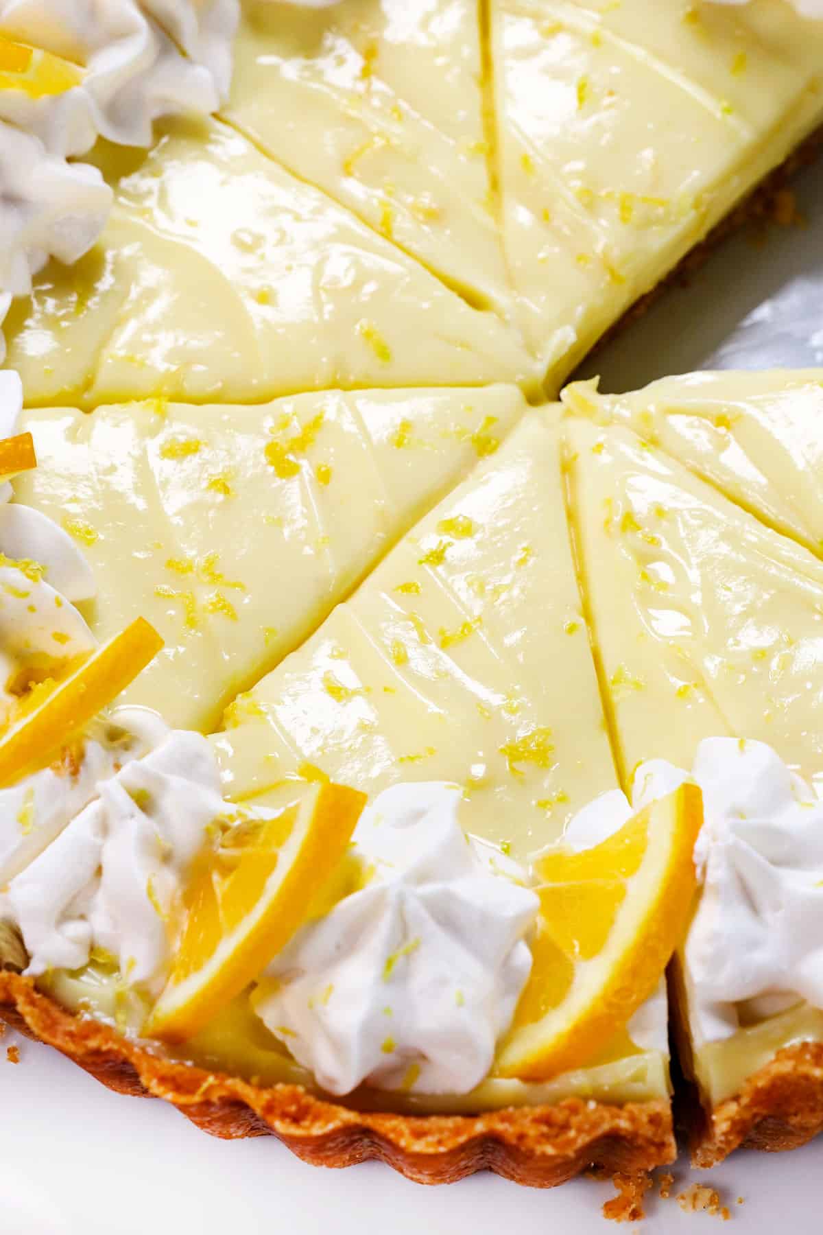 homemade lemon pie in slices topped with whipped cream