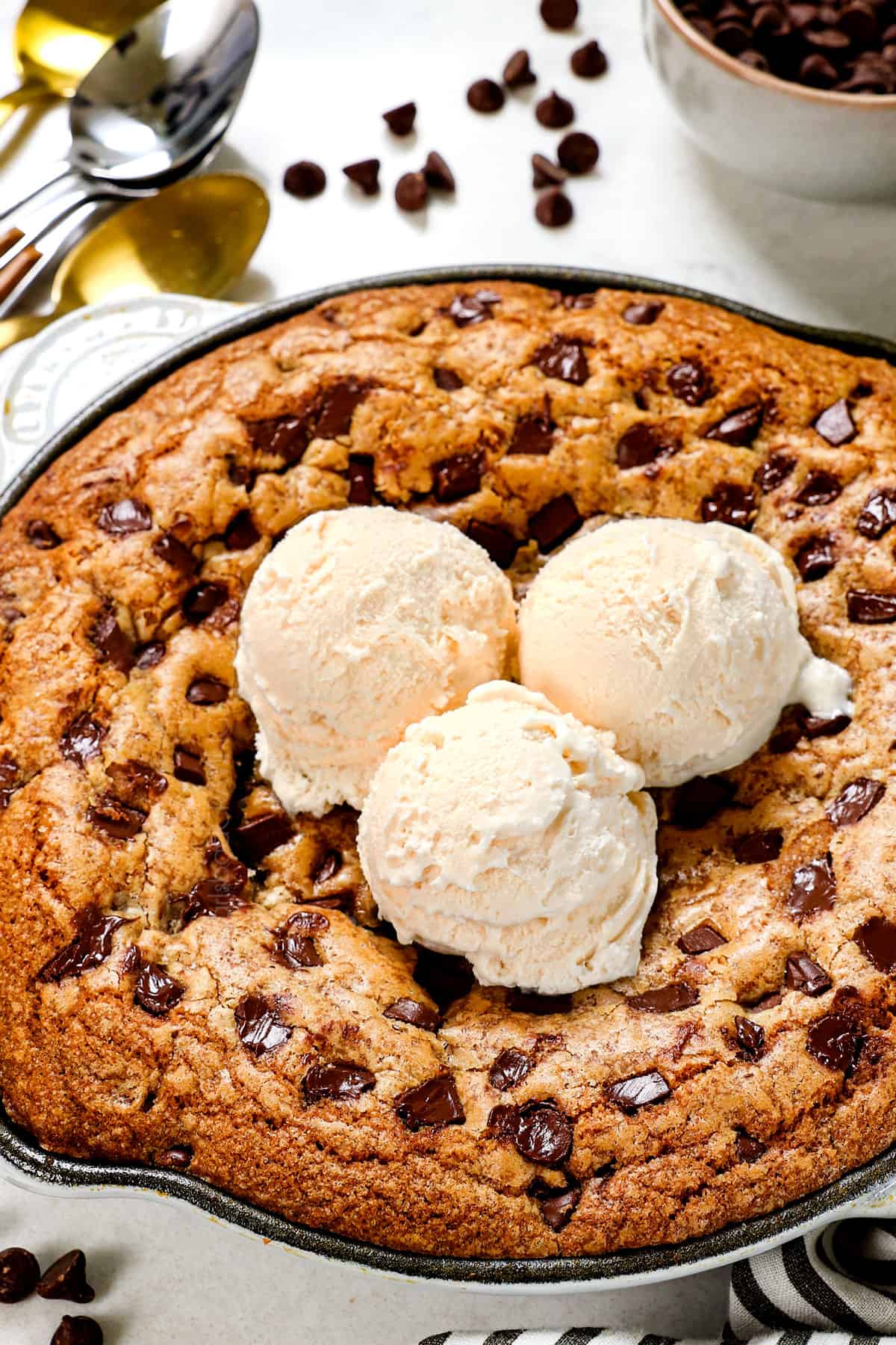 cookie skillet topped with ice cream in a cast iron skillet