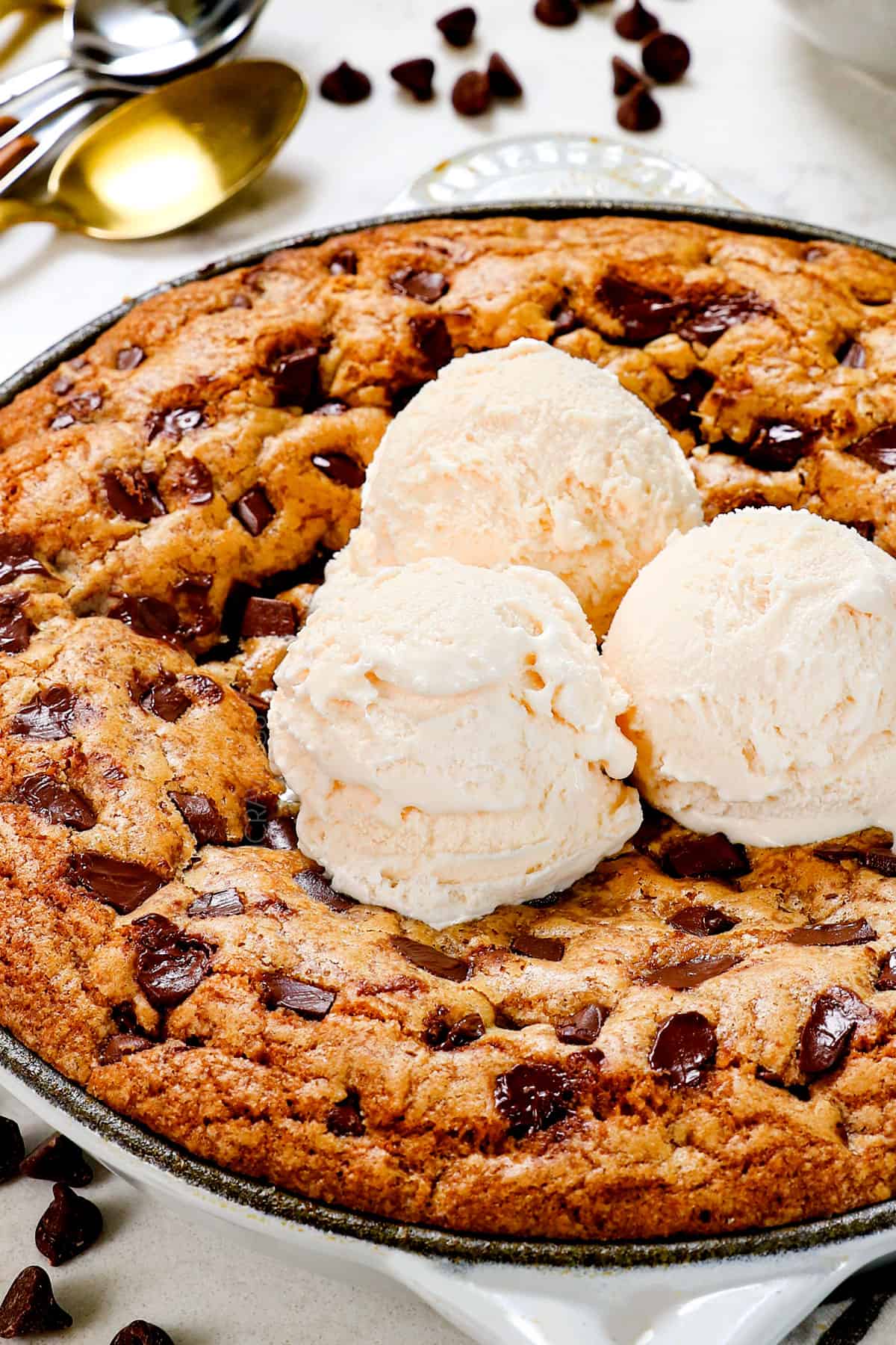 cookie skillet topped with ice cream in a cast iron skillet