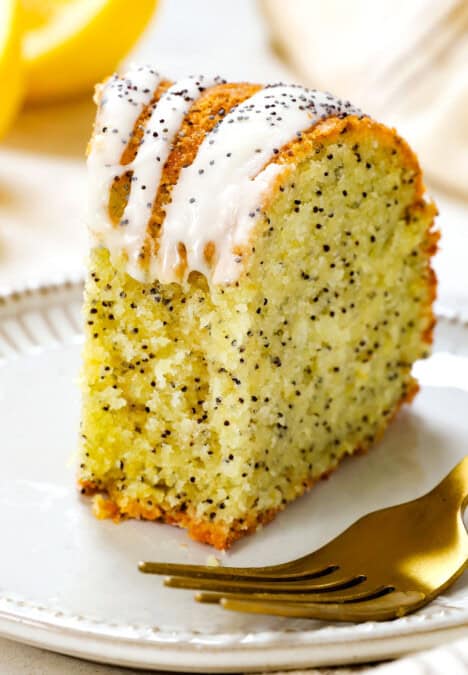 up close of lemon poppy seed cake with a bite taken out showing how tender the cake is