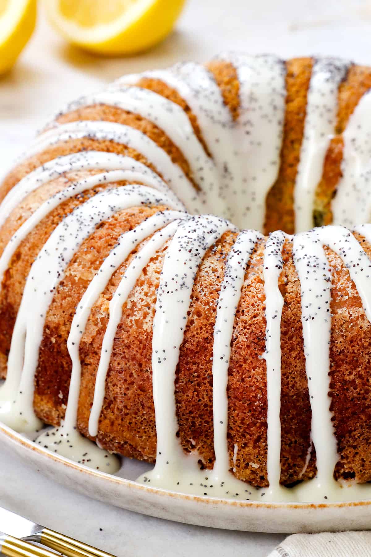 showing how to make lemon poppy seed cake by drizzling with glaze