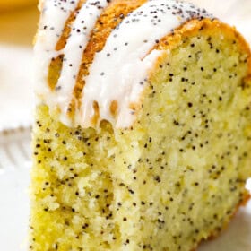 up close of lemon poppy seed cake with a bite taken out showing how tender the cake is