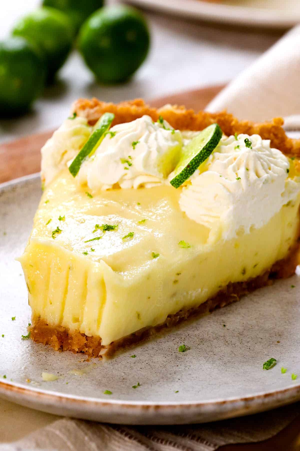 a slice of key lime pie with a bite taken out showing how creamy it is
