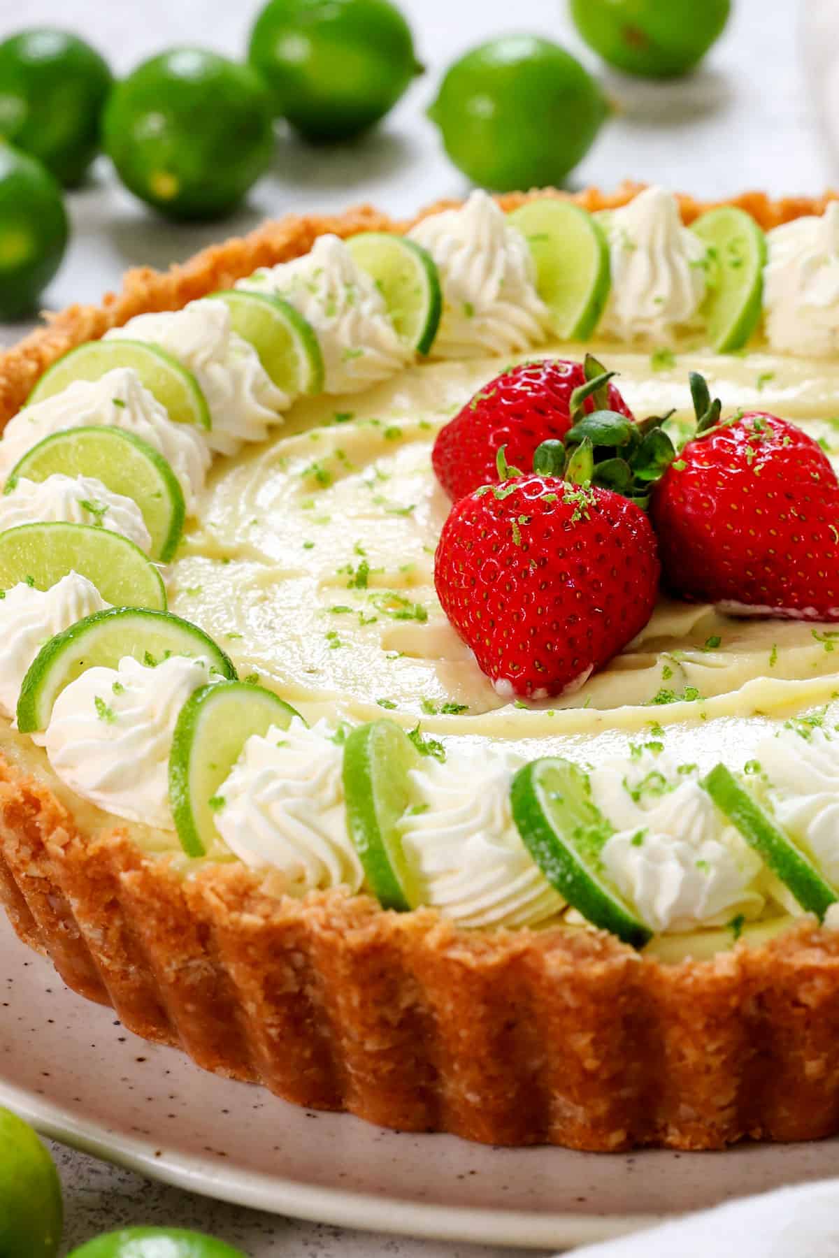 showing how to make  key lime pie by topping with whipped cream 