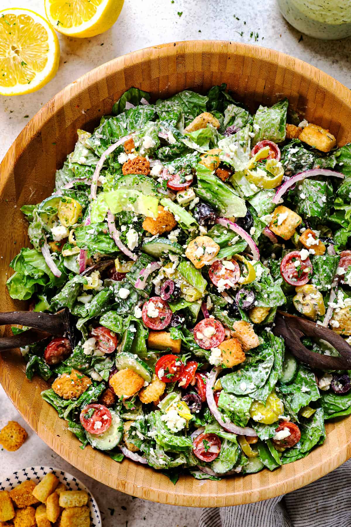 showing how to make traditional 
 Mediterranean salad recipe by tossing the salad together