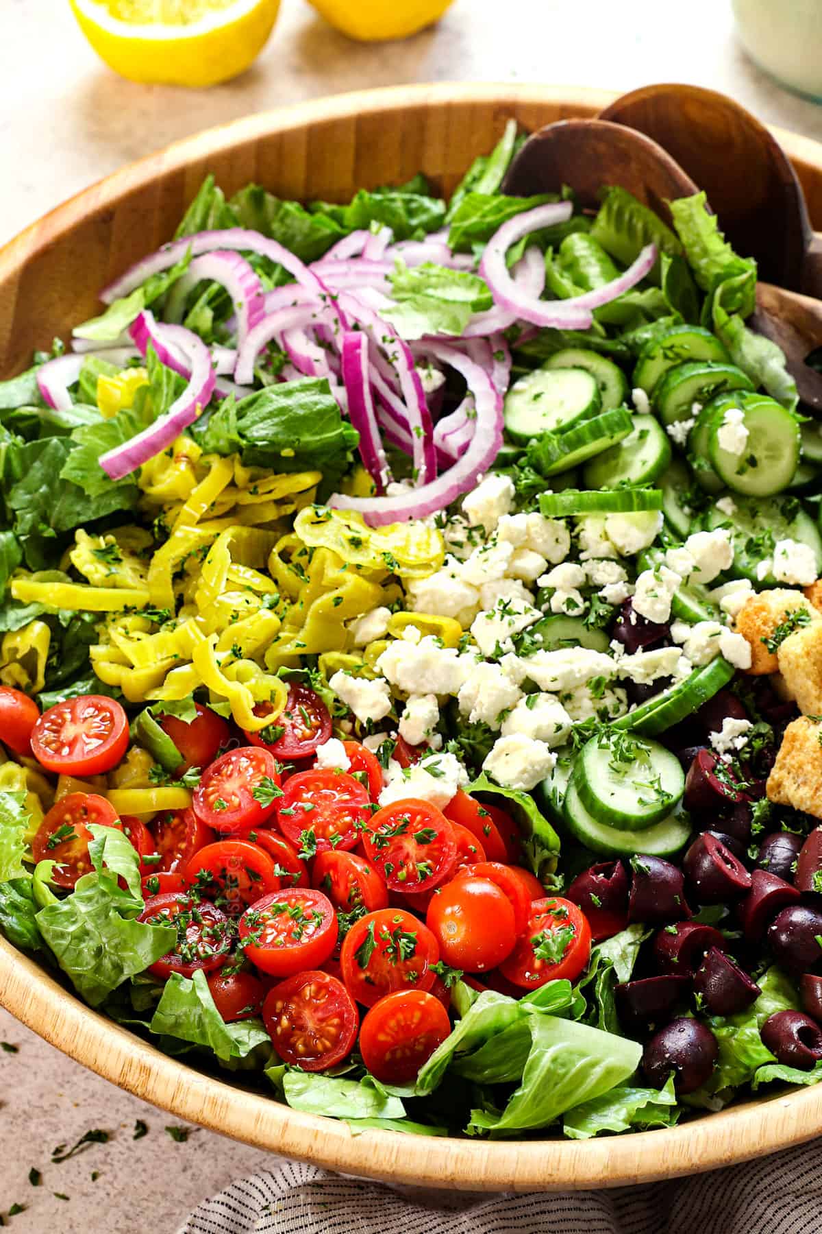 showing how to make Mediterranean salad recipe by adding the ingredients to a bowl