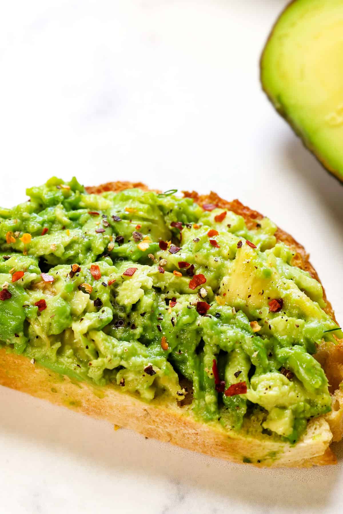 avocado toast topped with red pepper flakes