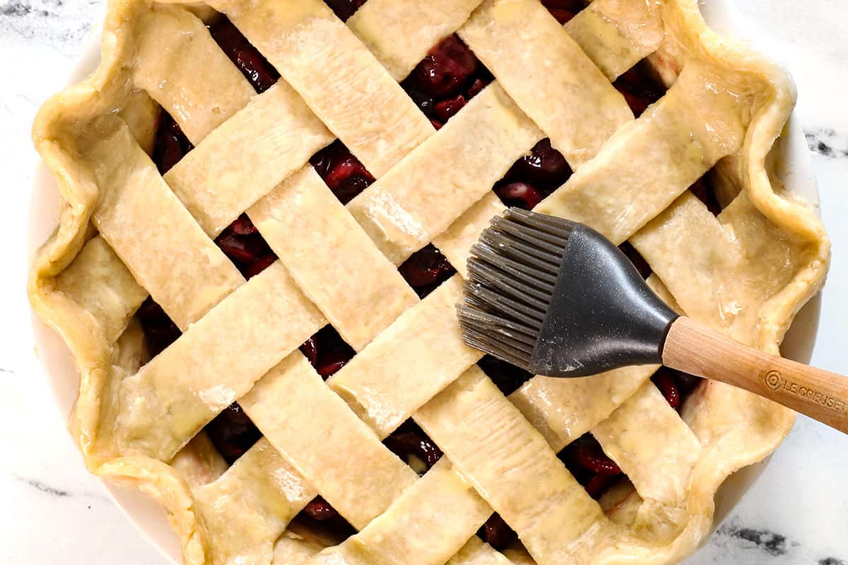 showing how to make cherry pie recipe by brushing the dough with an egg wash before baking