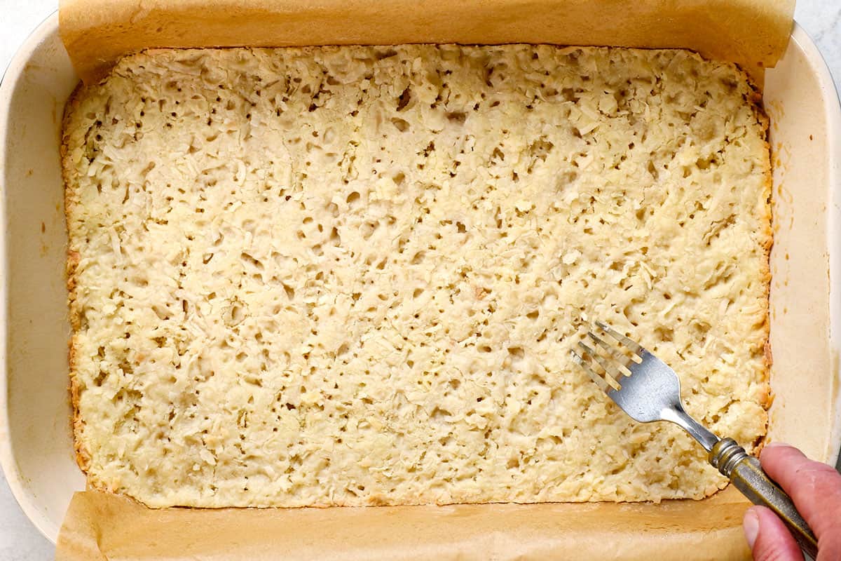 showing how to make lemon bars by baking the crust until lightly golden around the edges 