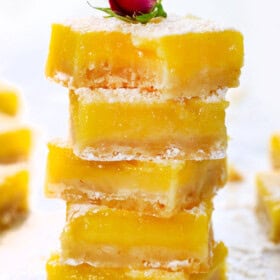 a stack of lemon bars showing how thick and creamy they are